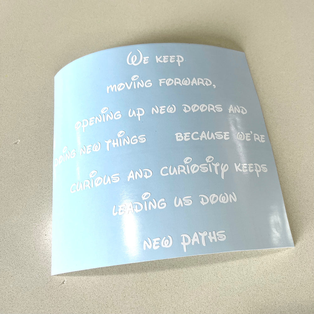 White motivational quote decal on curled backing