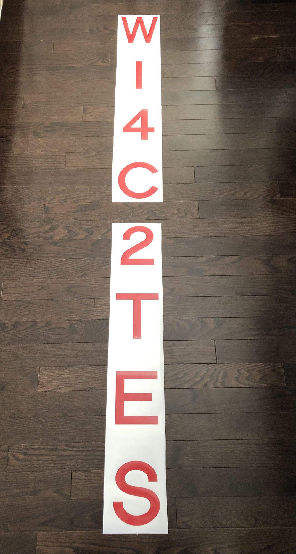 Pink vertical letters and digits on separate backing strips