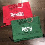 Red Amelia and green Remy Santa sacks laid flat