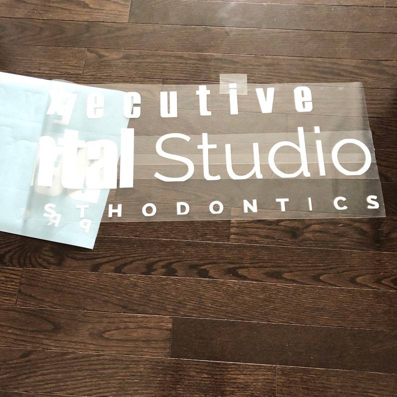 White Executive Dental Studio Orthodontics lettering on backing