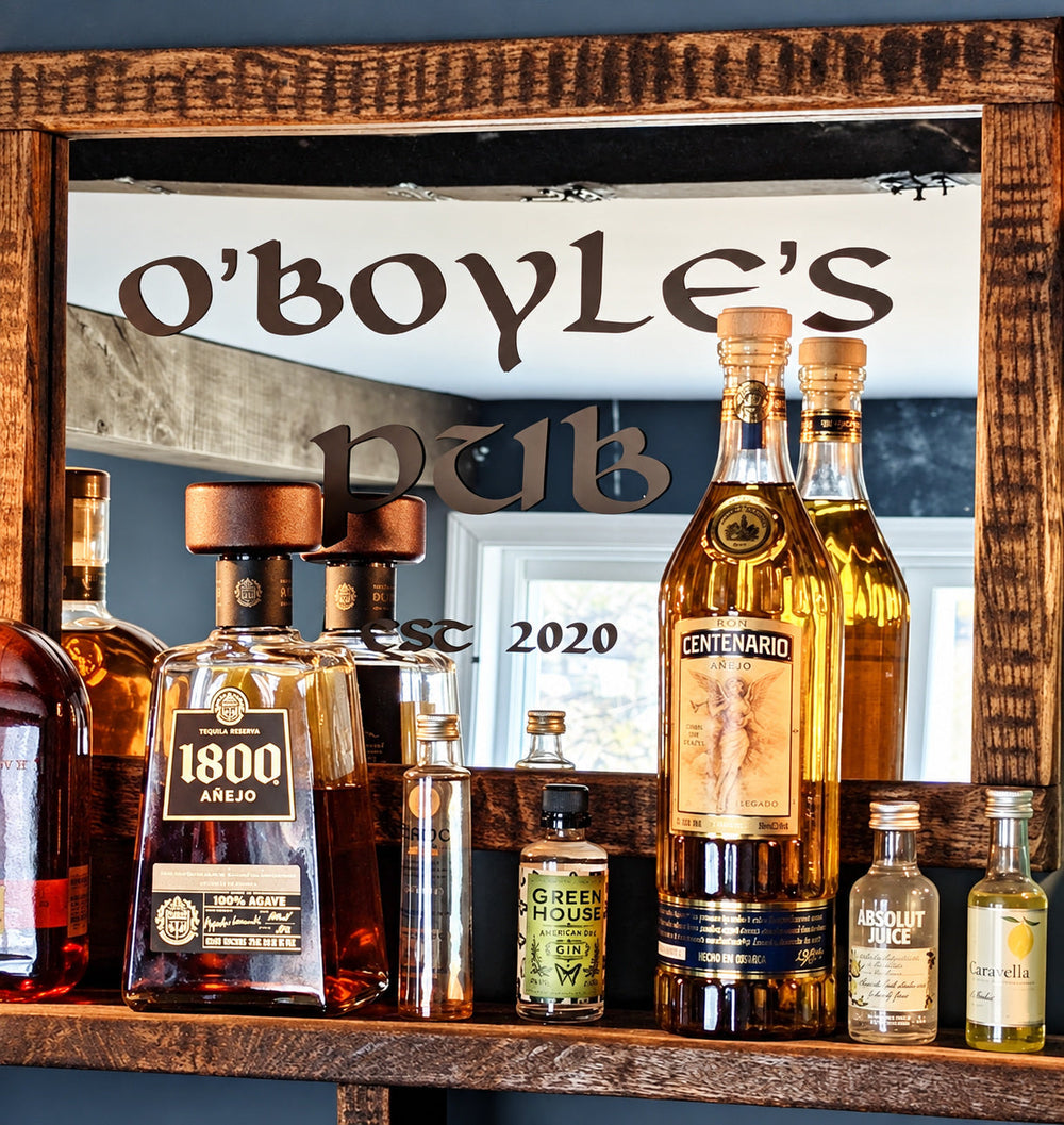 O’Boyle’s pub lettering on a framed bar mirror behind bottles