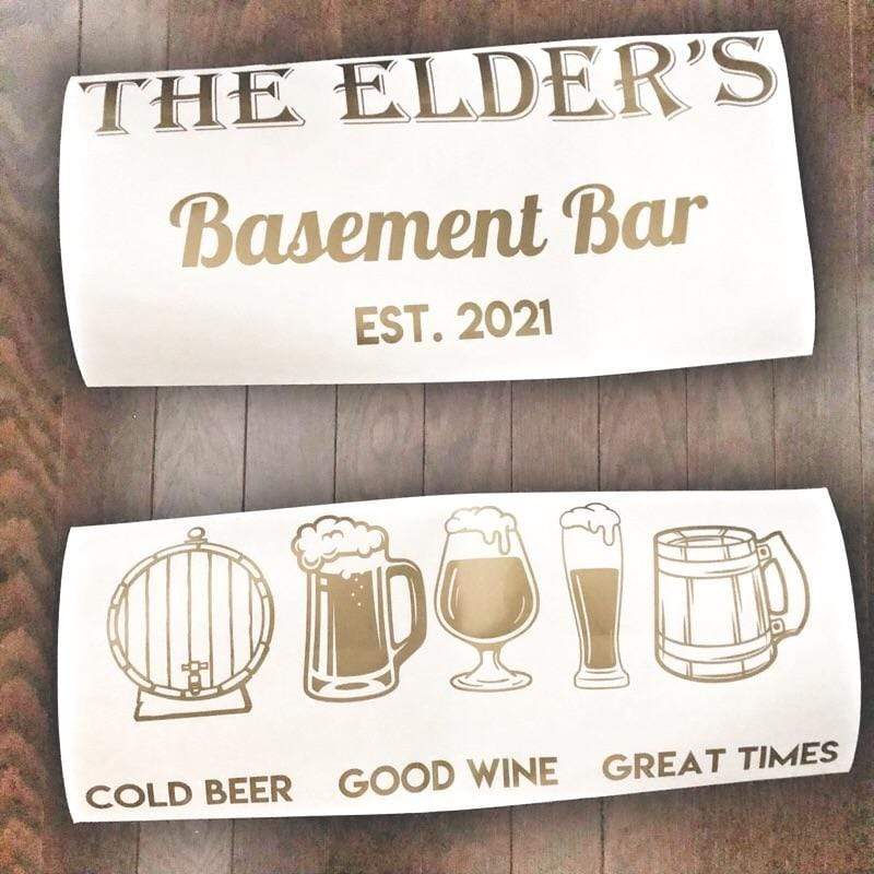 Gold-coloured Elder’s Basement Bar lettering and drink icons on backing