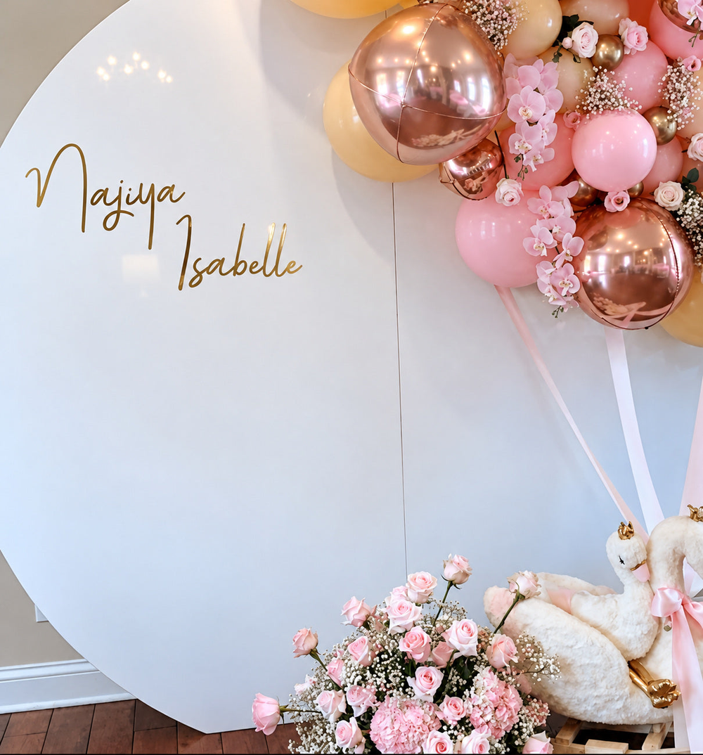 Nayva Isabelle lettering on a round event display with balloons