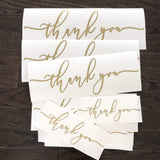 Gold-coloured Thank You script decals on backing sheets