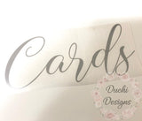 Silver-coloured Cards script decal on backing