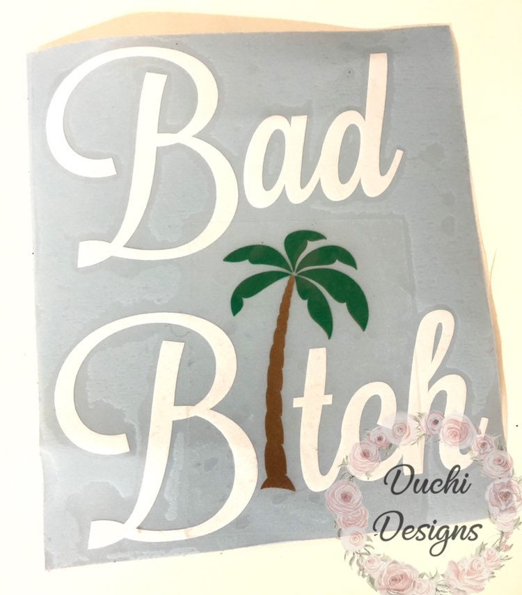 White two-line phrase decal with a green palm-tree design
