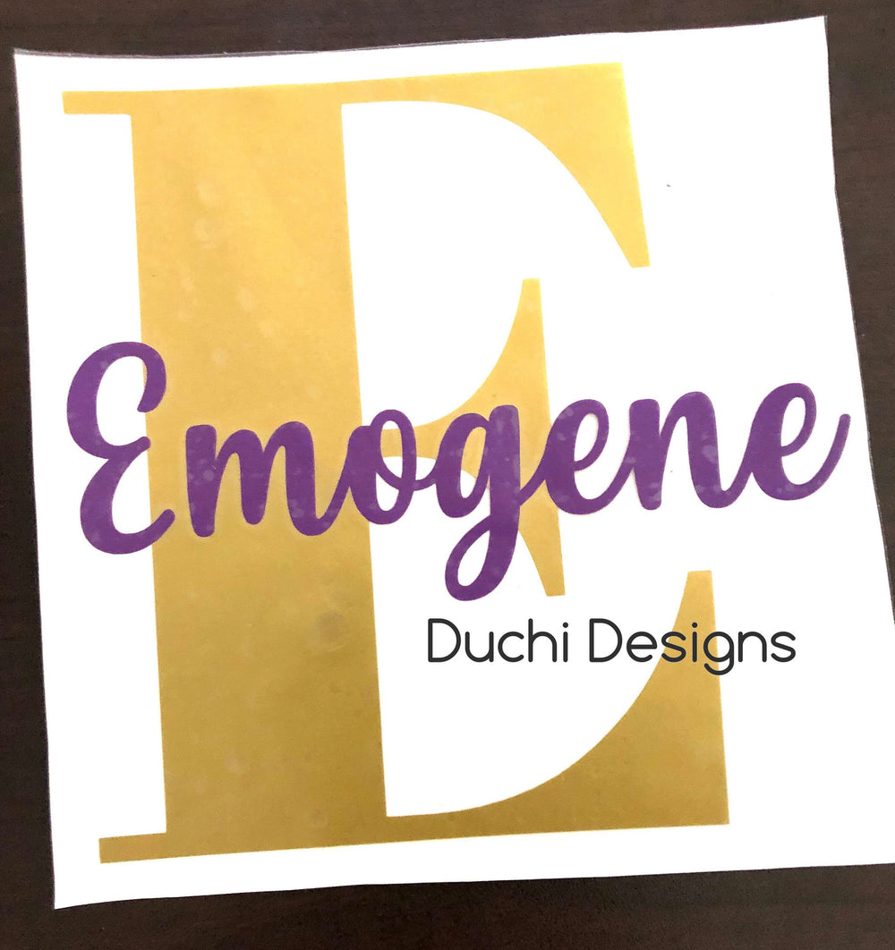 Gold-coloured initial E with purple Emogene script
