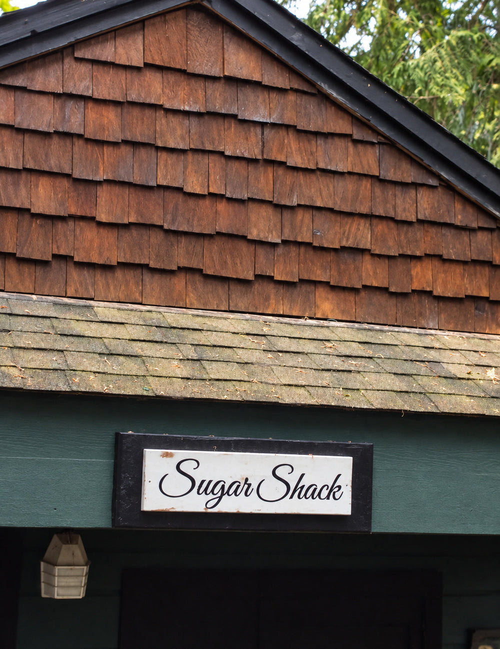 Sugar Shack lettering displayed above a rustic building entrance