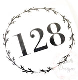 Black 128 house numbers within a leafy wreath