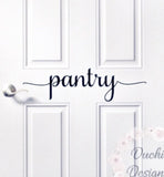 Black pantry script lettering on a white door