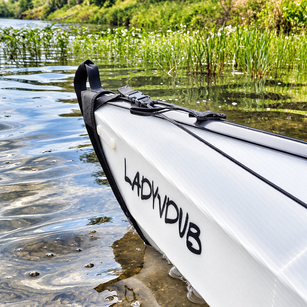 Black AQHDYB lettering on a white kayak on water