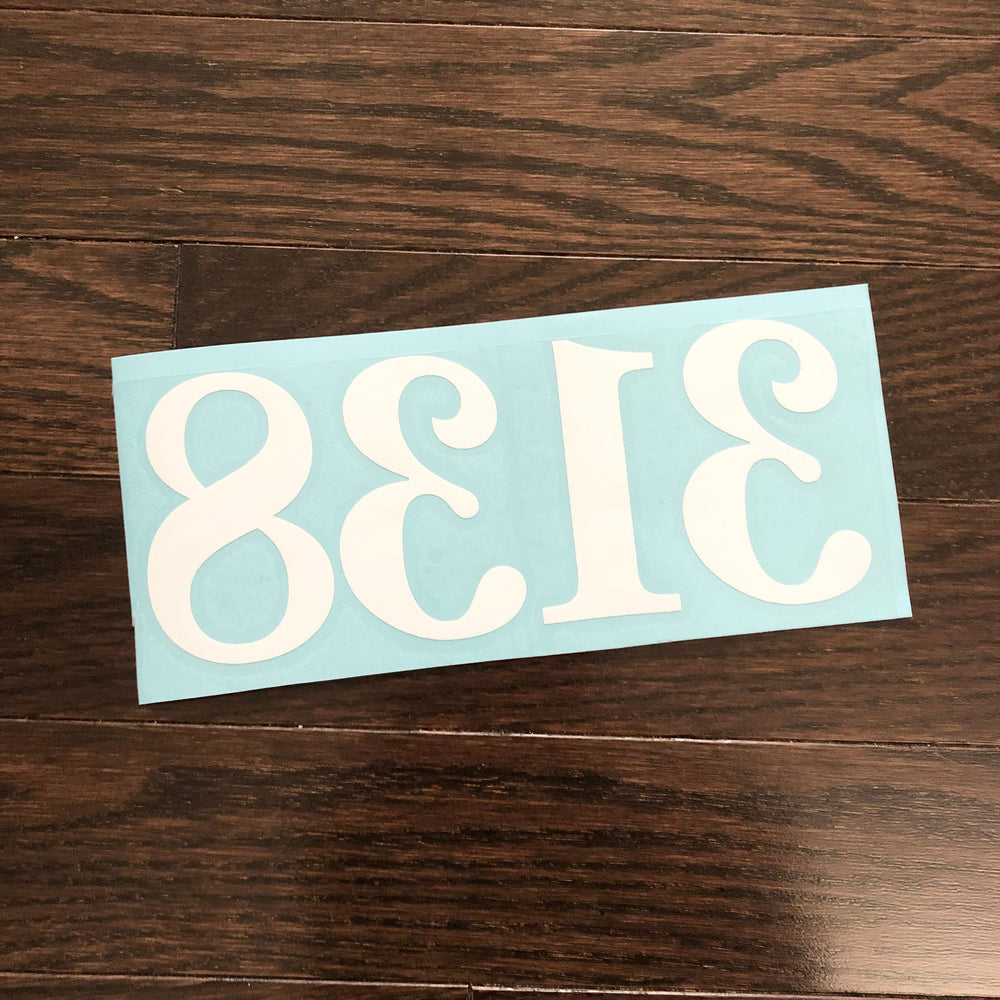 Reverse-oriented white 3138 number decal on blue backing
