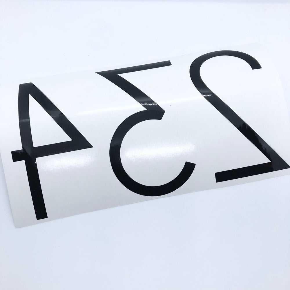 Reverse-oriented black 234 number decal on backing