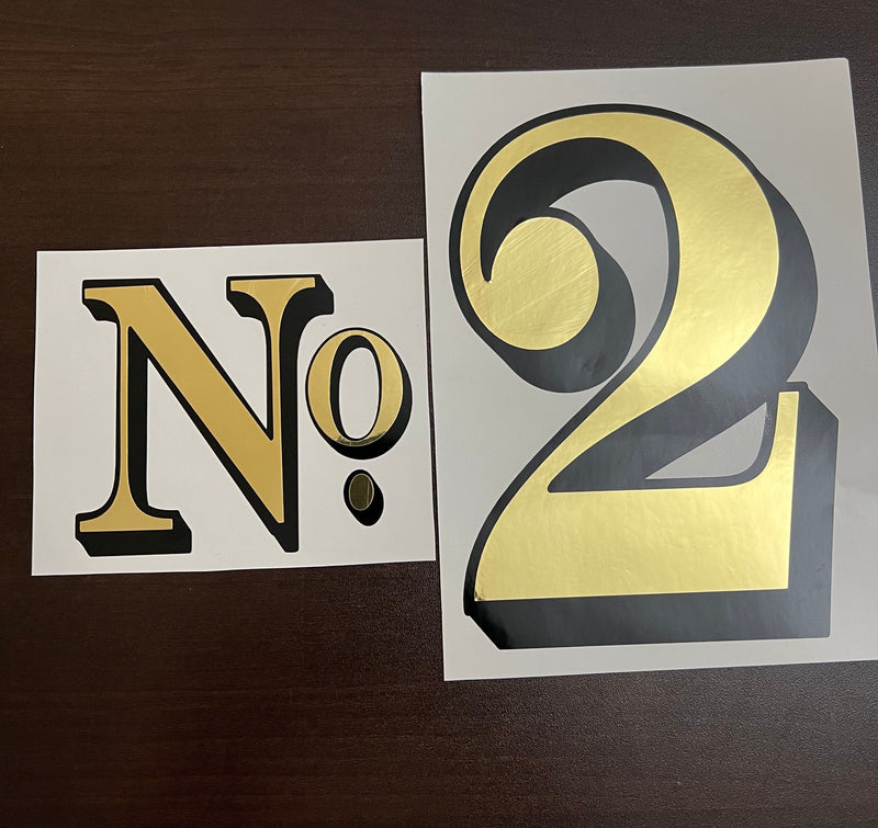 Gold and black No. 2 decal on backing